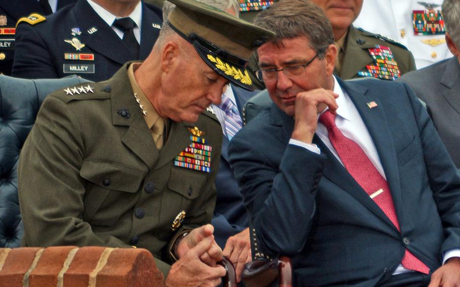 Gen. Joseph Dunford Jr., the incoming chairman of the Joint Chiefs of Staff, talks with Secretary of Defense Ash Carter during Gen. Martin Dempsey's farewell ceremony at Joint Base Myer-Henderson Hall, Va., Sept. 25, 2015.