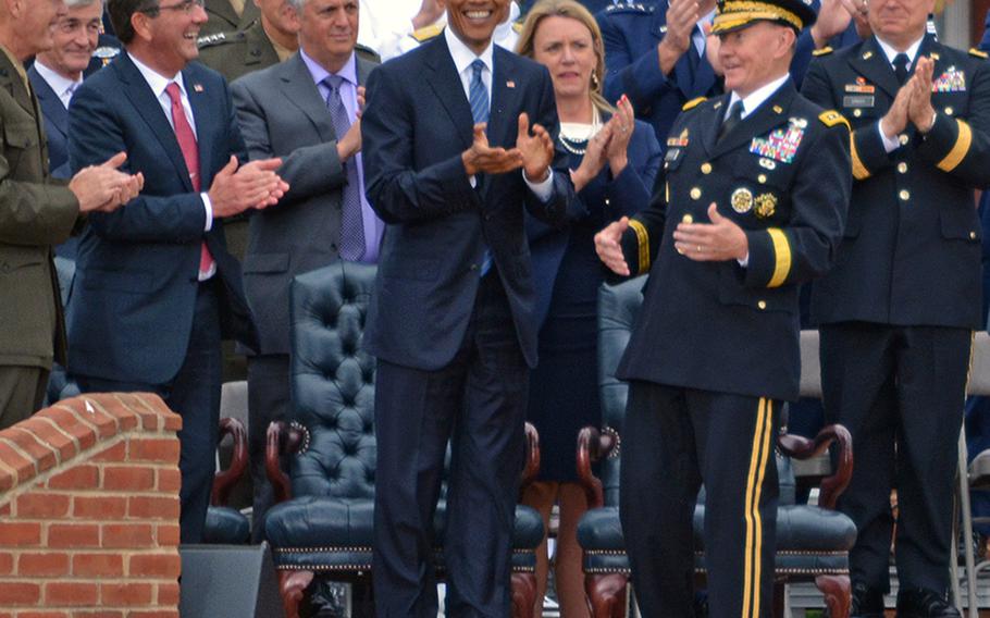 President Barack Obama leads the applause during the farewell ceremony for retiring Chairman of the Joint Chiefs of Staff Gen. Martin Dempsey, right foreground, at Joint Base Myer-Henderson Hall, Va., Sept. 25, 2015.