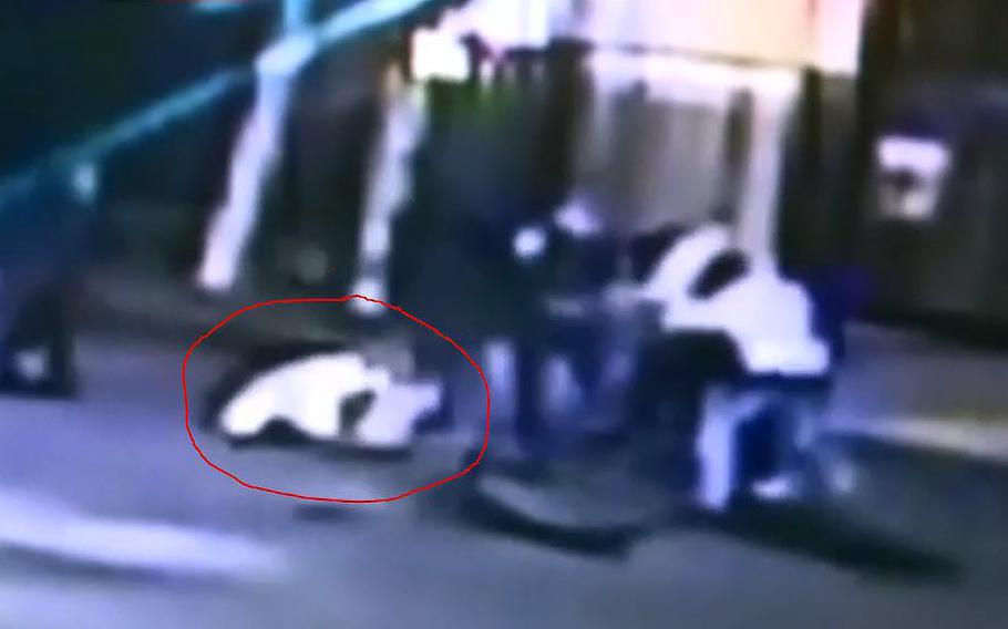 A video screen grab shows the fight outside a Sacramento bar where U.S. Airman Spencer Stone is seen on the ground with a red circle around him, after he was stabbed.