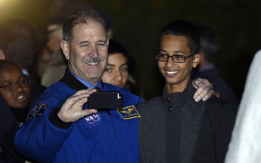 John M. Grunsfeld, left, NASA's Associate Administrator for the Science Mission Directorate, takes a photo with Ahmed Mohamed, right, the Texas teenager arrested after a homemade clock he brought to school was mistaken for a bomb during the second-ever White House Astronomy Night on the South Lawn of the White House in Washington, Monday, Oct. 19, 2015.