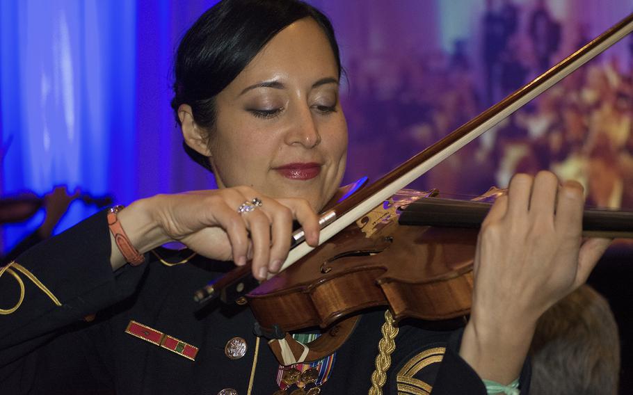 A member of the U.S. Army Strolling Strings band performs among the attendees at the Angels of the Battlefield Gala in Washington, D.C., on Nov. 4, 2015.