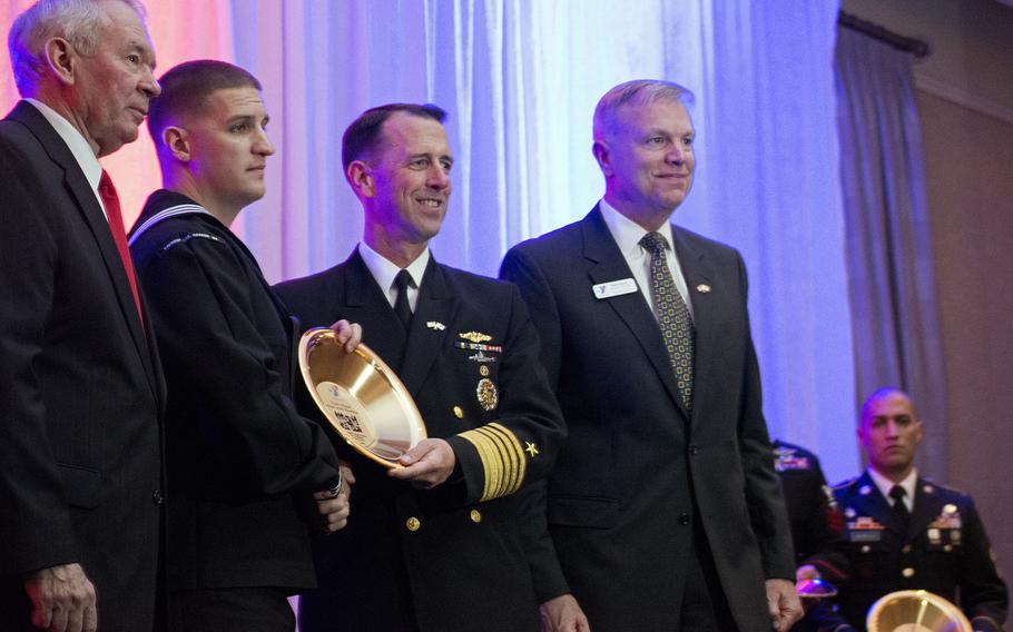 Petty Officer 1st Class Wayne Papalski receives an award from Adm. John Richardson, Chief of Naval Operations, while Chairman of the Board Michael Dodson (far left) and President and CEO Bill French, (far right), both of the Armed Services YMCA, look on. 