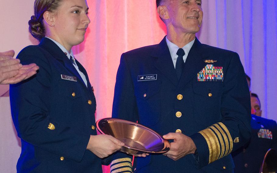 Commandant of the U.S. Coast Guard Admiral Paul Zukunft presents the Angles of the Battlefield honoree Petty Officer 2nd Class Mya Dejanakul with an award during the gala on Nov. 4, 2015. 
