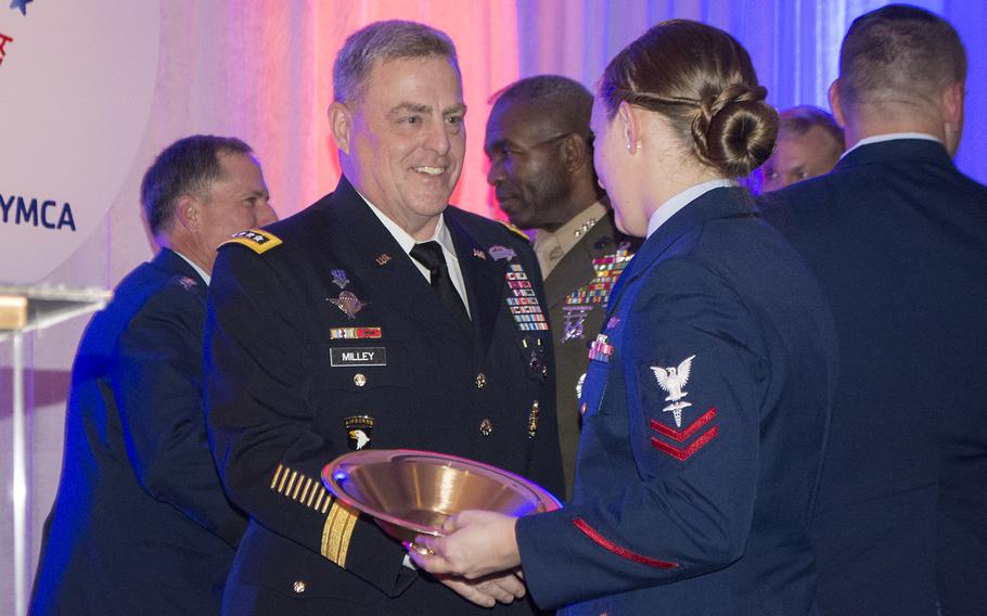 Petty Officer Second Class Mya Dejanakul shakes General Mark Milley's hand at the end of the Angels of the Battlefield gala on Nov. 4, 2015, in Washington, D.C.