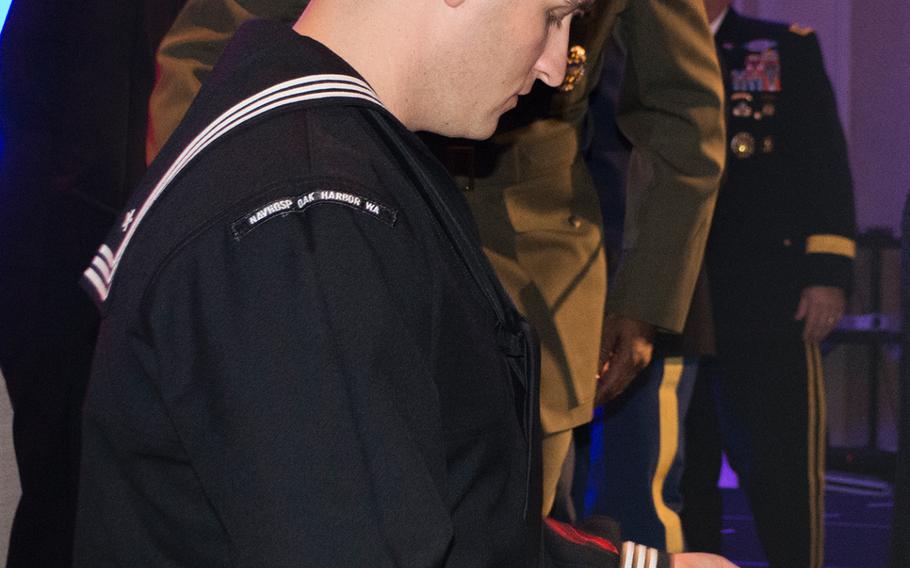 Petty Officer 1st Class Wayne Papalski looks at the award he received during the Angels of the Battlefield Gala in Washington, D.C., on Nov. 4, 2015. 