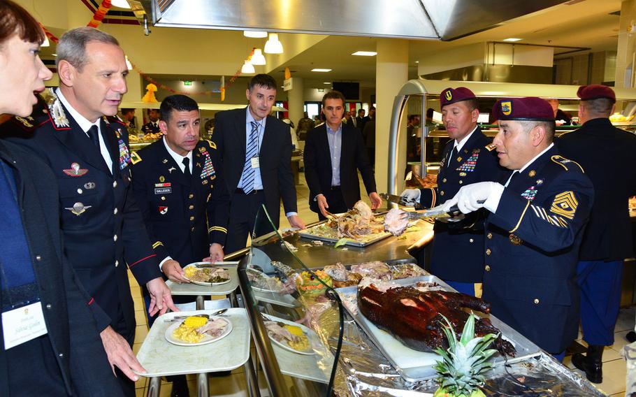 U.S. Army paratrooper 1st Sgt. Norberto Badillo, assigned to the 173rd Brigade Support Battalion, 173rd Airborne Brigade serves lunch to Italian Carabinieri Brig. Gen. Paolo Nardone, commander COESPU (Center of Excellence Stability Police Units) during the Thanksgiving lunch celebration at Caserma Del Din in Vicenza, Italy on Nov. 24, 2015.