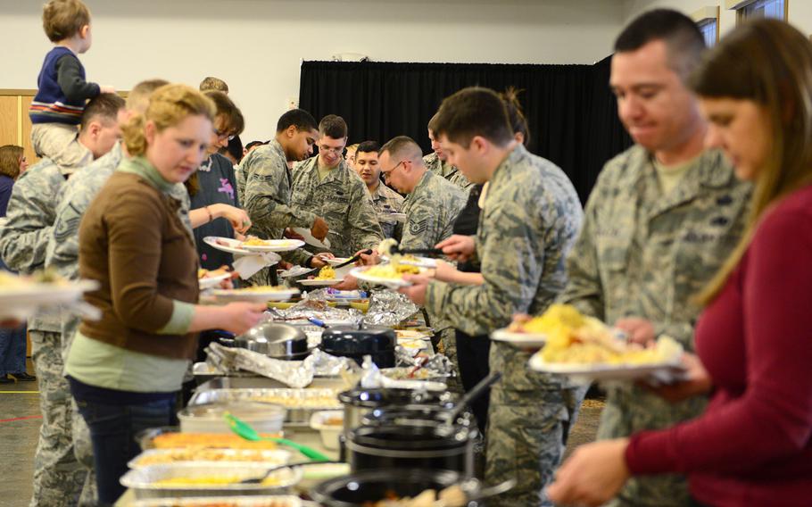 U.S. Air Force Airmen with the 354th Communications Squadron (CS) enjoy their families and food at a Thanksgiving potluck Nov. 20, 2015, at Eielson Air Force Base, Alaska. The 354th CS gathered for the holiday to promote esprit de corps.