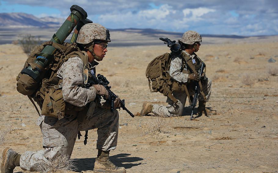 Marine Sgts. Emma A. Bringas, left, and Amaya Marin Garnica take cover while maneuvering to conduct an enemy counter attack during an exercise at Range 107, Marine Corps Air Ground Combat Center Twentynine Palms, Calif., on March 2, 2015.