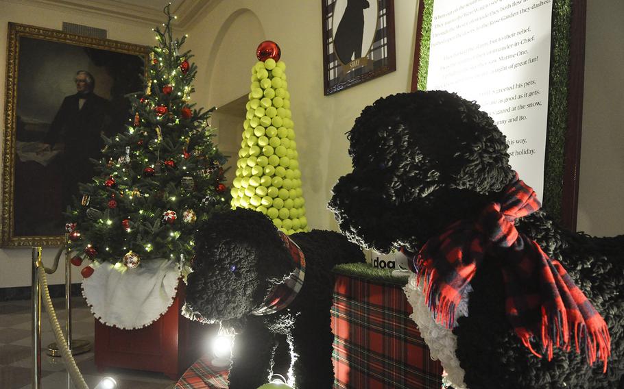 First Dogs Bo and Sunny are recreated with nearly 55,000 feet of yarn knitted into 7,000 pom-poms as part of a Christmas display including tennis ball Christmas trees at the White House. Lady Michelle Obama hosted a preview of holiday decorations for military families on Dec. 2, 2015.