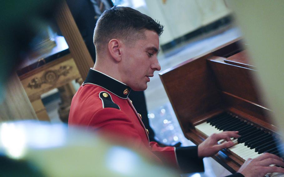 A Marine plays the piano during First Lady Michelle Obama's preview for military families of White House holiday decorations on Dec. 2, 2015.
