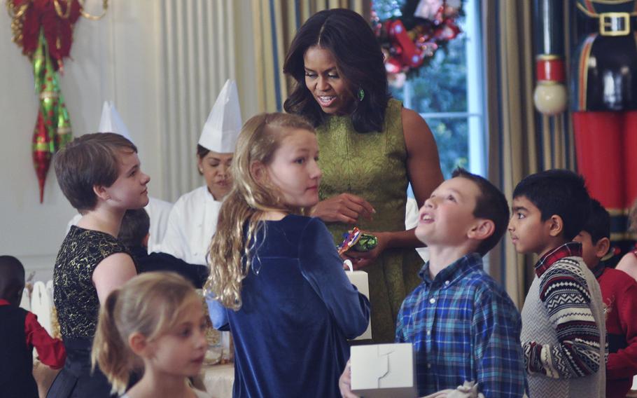 First Lady Michelle Obama chats with the children of military families at the White House during a cookie decorating event on Dec. 2, 2015 . Obama was hosting a preview of White House holiday decorations for military families.