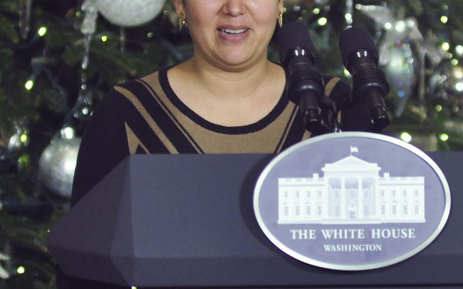 Cicilia Wong-Lopez, whose husband is in the Navy, introduces First Lady Michelle Obama at the White House on Dec. 2, 2015. Obama was hosting a preview of White House holiday decorations for military families. Wong-Lopez, from Alexandria, Va., was among volunteer decorators who decked out the executive residence.