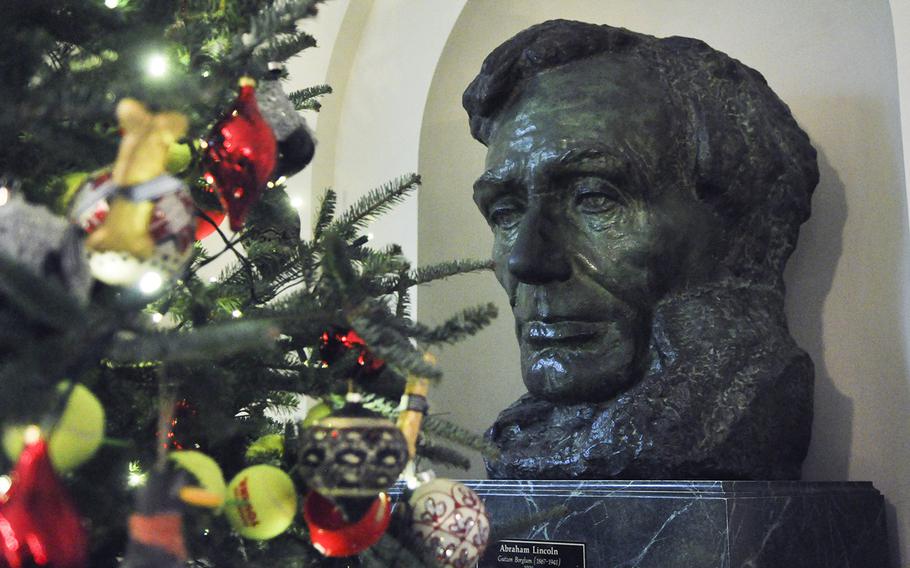 A bust of Abraham Lincoln sits next to a Christmas tree decorated with tennis balls in the East Garden Room of the White House on Dec. 2, 2015.  First Lady Michelle Obama was hosting a preview of holiday decorations for military families.