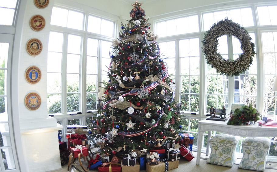 A military-themed Christmas tree is the focus of the sunroom at the Vice President's residence on Dec. 8, 2015. The tree is adorned with ornaments with the seals of each military branch, and ornaments made by military children.