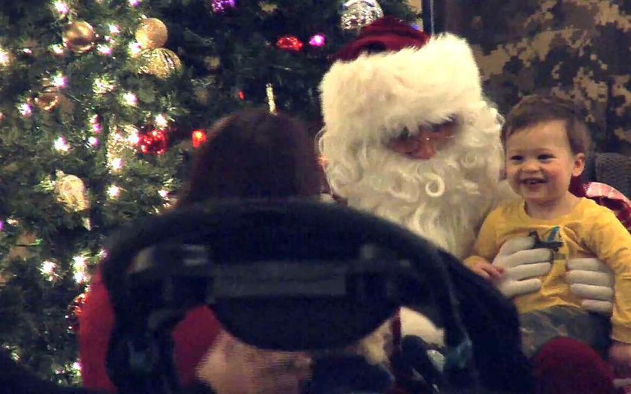 A video screen grab shows Santa meeting with children during an Operation Homefront outreach to military families in Clinton, Md., on Tuesday, Dec. 8, 2015.