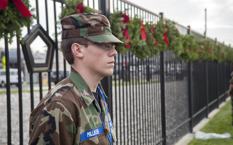 Civil Air Patrol cadets stand at attention after wreath-hanging event at the Pentagon in Arlington, Va., on Friday, Dec. 11, 2015. The wreaths honored the 184 victims who died on Sept. 11, 2001, when a hijacked aircraft was crashed into the side of the Pentagon.