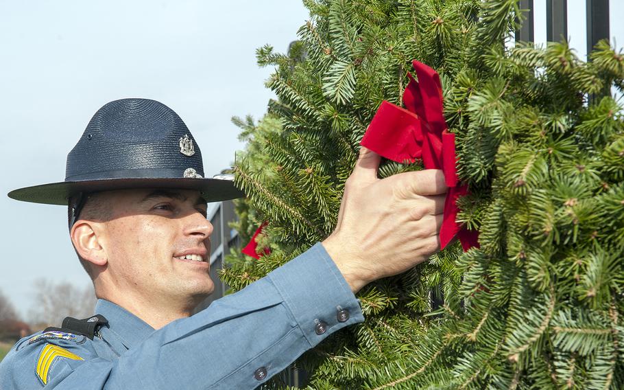 Maine State Police Sgt. Mark Holmquist helps hang wreaths at the Pentagon in Arlington, Va., on Friday, Dec. 11, 2015. The wreaths honored the 184 victims who died on Sept. 11, 2001, when a hijacked aircraft was crashed into the side of the Pentagon.