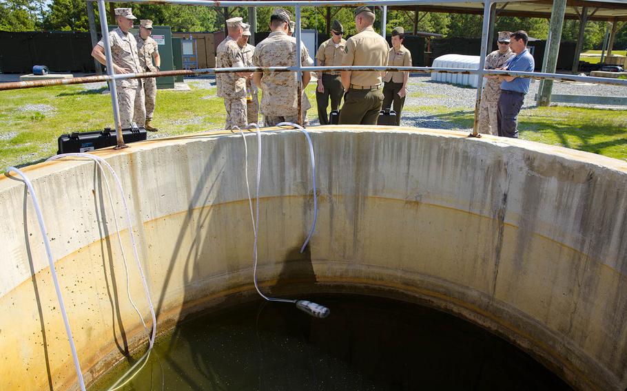 Water lines for a small unit water purification system prototype draw water from a reservoir at Camp Lejeune, N.C., May 9, 2014.