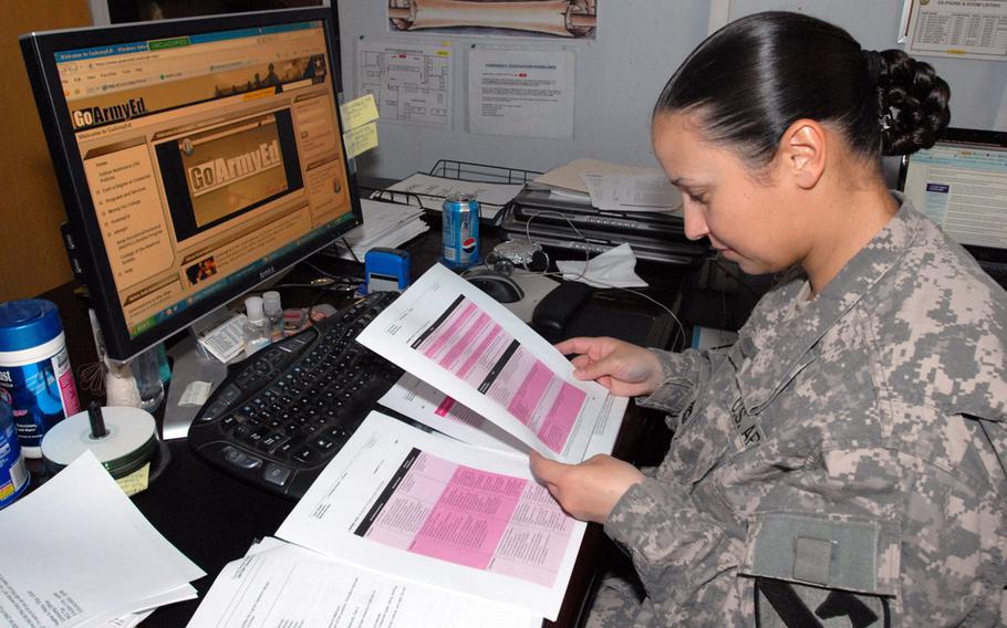 In a 2009 file photo, a soldier with 1st Cav. Div., Multi-National Division-Baghdad, works on a statistics lesson in the Masters in Business Administration program at the University of Phoenix online during her lunch hour.