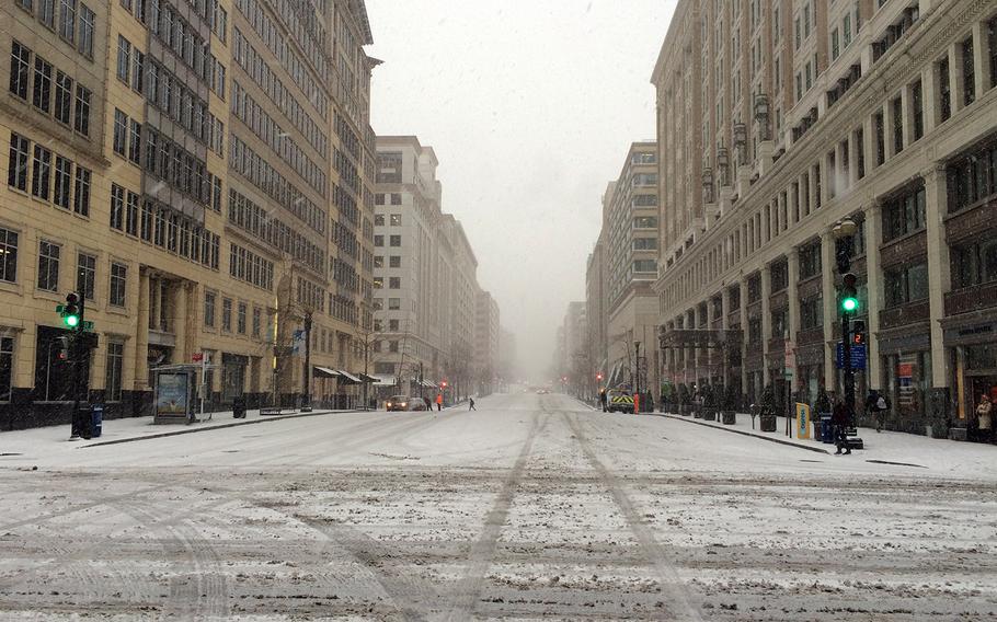 On what should be a busy Friday afternoon, 13th St. in Washington, D.C. is deserted as a snowstorm begins.