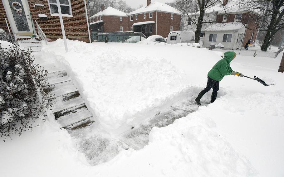 Mae Richardson shovels snow outside her home in Parkville, Md., Saturday, Jan. 23, 2016.