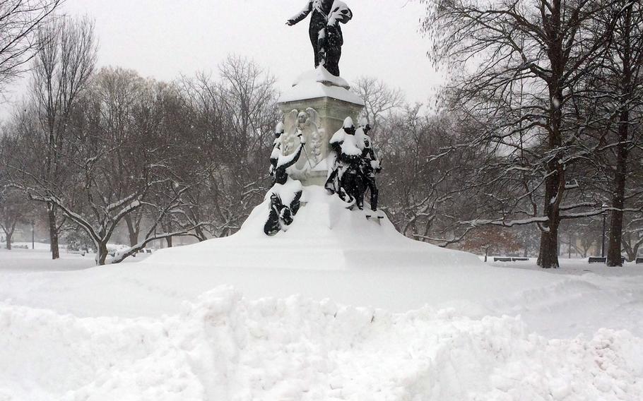 Snow covers the lower part of the statue of the statue of the Marquis de Lafayette in Washington, D.C.'s Lafayette Park during a blizzard on Saturday, Jan. 23, 2016.