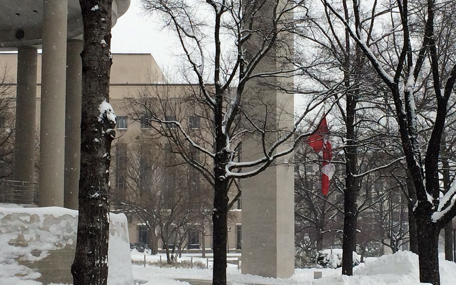 The flag of a nation that knows something about blizzards lends color to the scene at the Canadian embassy on Saturday, Jan. 23, 2016.