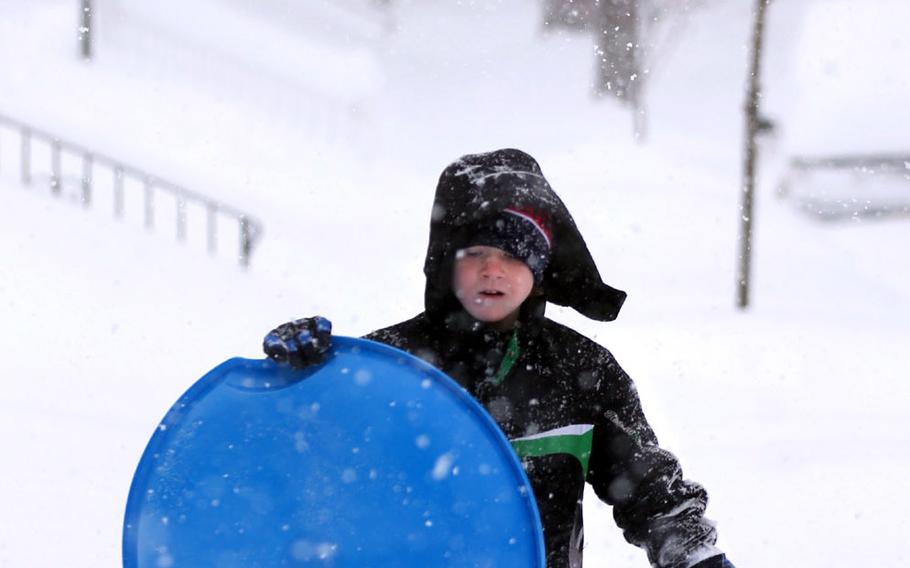 Garrett Stickley, 10, of Winchester, Va., finds the snow above his knees as he heads out to play on Saturday, Jan. 23, 2016.