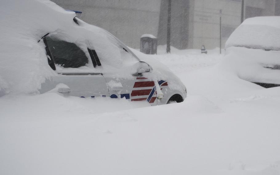A police car is partially buried in SW D.C. during a blizzard on Jan. 23, 2016.