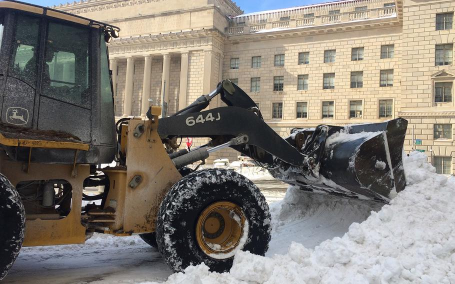 Clearing snow in Washington, D.C. on Jan. 25, 2016, in the wake of a weekend blizzard.