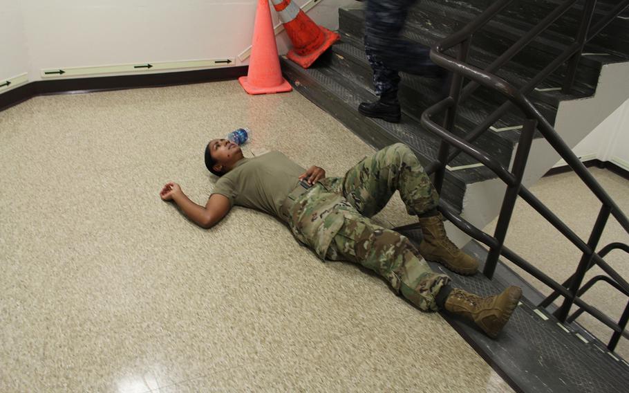 A servicewoman is in shock after being shot during a drill at Uniformed Services University of Health Services in Bethesda. The drill was a part of an active shooter exercise aimed to prepare for on-campus shootings.
