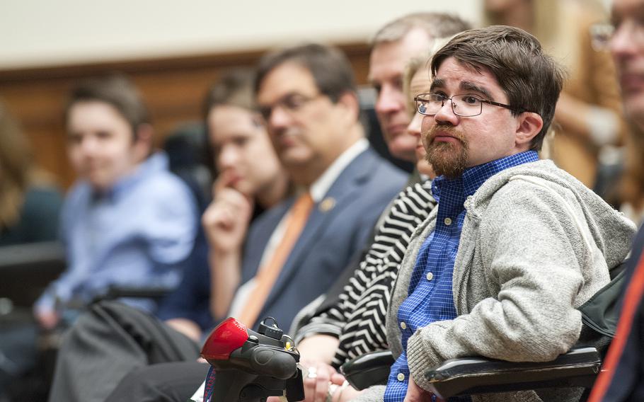 Buddy Cassidy, 26, who suffers from Duchenne muscular distrophy, listens as rock legend Roger Daltrey, lead singer of The Who, and other guests hold a panel discussion hosted by the House Energy and Commerce Committee, on Wednesday, March 23, 2016, on Capitol Hill in Washington, D.C., about the merits of the 21st Century Cures Act. The House passed the measure in July, and it is awaiting a vote in the Senate.