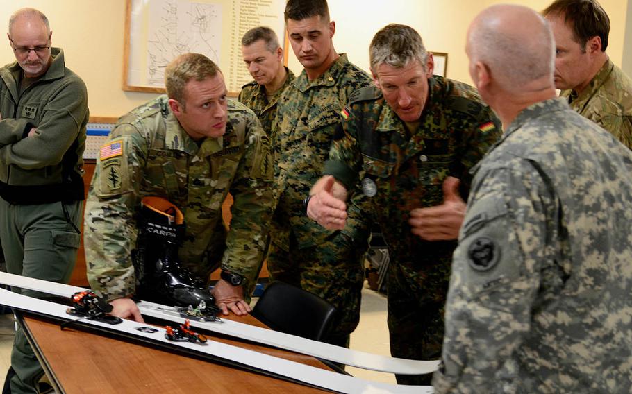 Military mountaineering and cold-weather professionals exchange ideas and opinions about a beta version of skis and bindings being developed by special forces during the Cold Regions Military Mountaineering Collaborative Training Symposium held this week at the Northern Warfare Training Center's Black Rapids Training Site in Alaska.