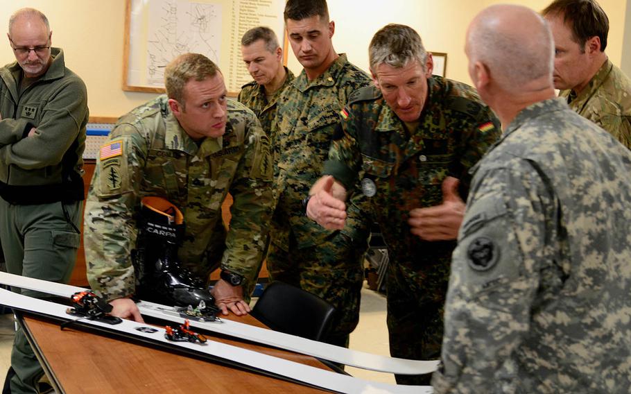 Military mountaineering and cold-weather professionals exchange ideas and opinions about a beta version of skis and bindings being developed by special forces during the Cold Regions Military Mountaineering Collaborative Training Symposium held this week at the Northern Warfare Training Center's Black Rapids Training Site in Alaska. 
