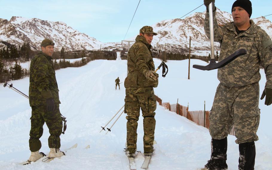 Lt. Col. Thomas Salberg, left, commander of the Great Britain 24th Commandos, and Lt. Col. Francois Caron, center, of the Canadian Army Advanced Warfare Training Centre prepare to ride the lift at the Northern Warfare Training Center at Black Rapids Training Site, Alaska, March 22, 2016. 

