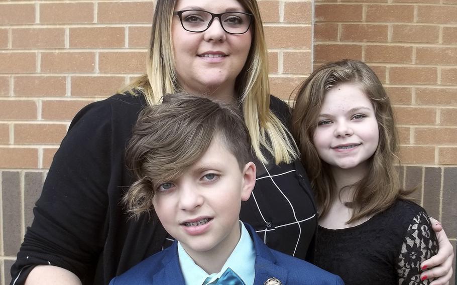 Tiffany Eckert embraces her son Myles and daughter Marlee at an Arlington, Va., hotel on Friday, March 25, 2016, as they prepared to attend the 2016 Citizen Honors Award at Fort Myers-Henderson. 