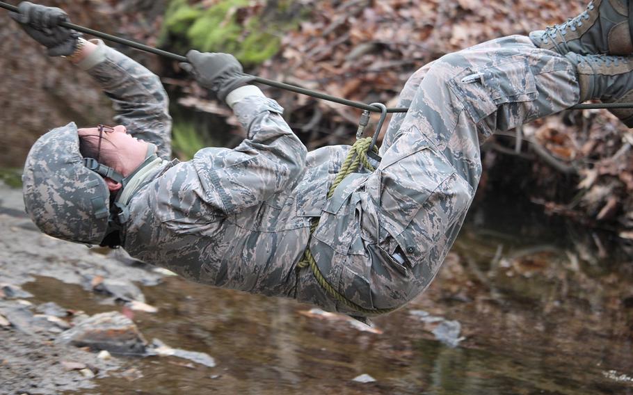 Air Force 2nd Lt. Connie Lin, a third-year medical student, participates in an exercise that requires her to get from one end of a line to another and transport a life-like test dummy across a stream during the "Gunpowder Challenge."