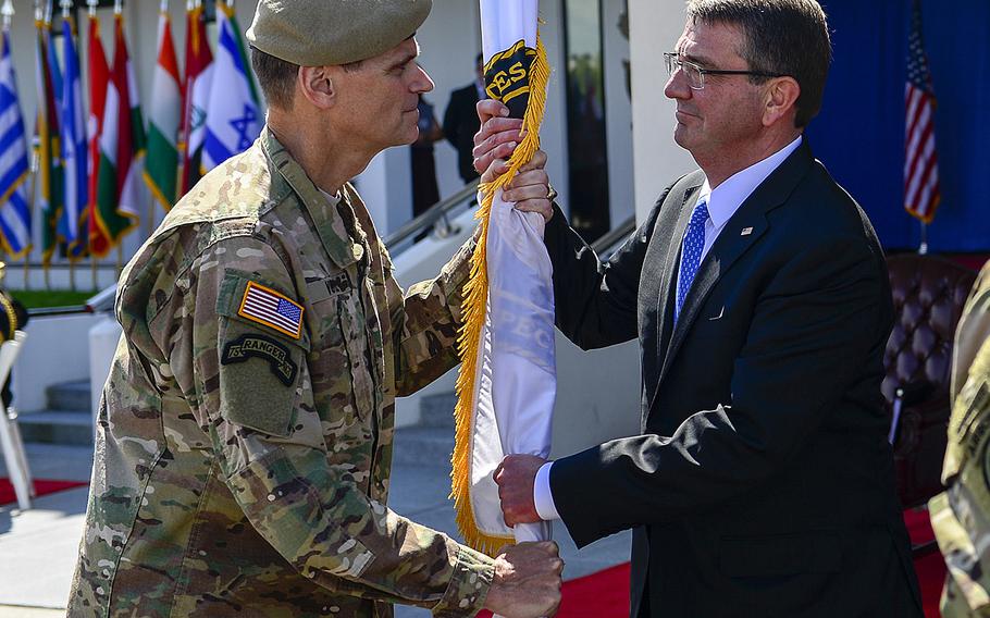 Army Gen. Joseph L. Votel, former commander of U.S. Special Operations Command, passes the guidon to Secretary of Defense, Ashton Carter, during the change-of-command ceremony March 30 at MacDill Air Force Base, Fla. 