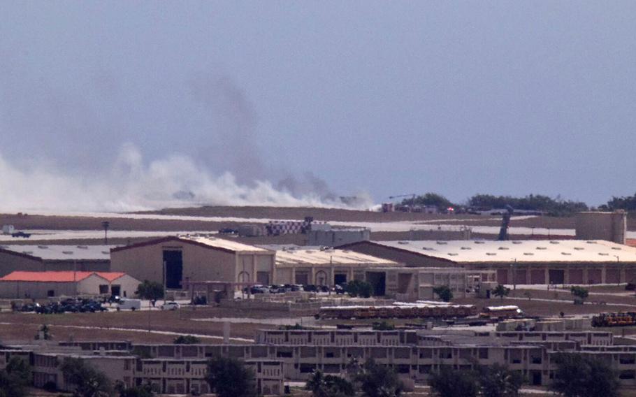 Smoke from the crash of a B-52 is seen on the flight line at Andersen Air Force Base from Mt. Santa Rosa, Yigo Guam, Thursday, May 19, 2016. The U.S. Air Force said Thursday a B-52 crashed on Guam shortly after takeoff, but all seven crew members made it out safely. No injuries were reported.