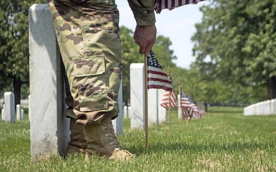 Servicemembers participate in Flags In at Arlington National Cemetery on May 26, 2016.