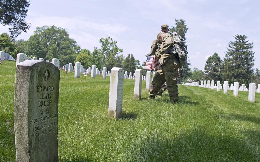 Servicemembers participate in Flags In at Arlington National Cemetery on May 26, 2016.