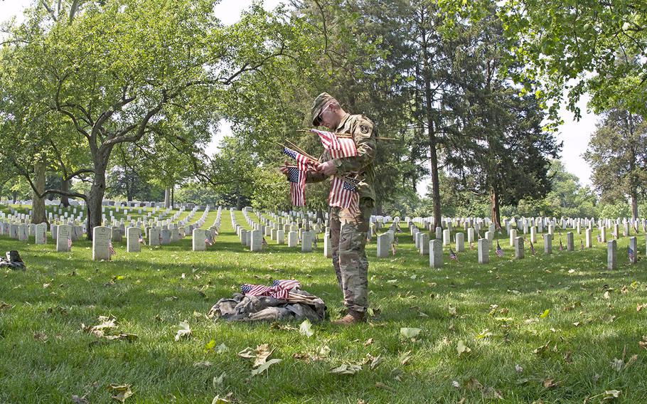 Servicemembers participate in Flags In at Arlington National Cemetery on May 26, 2016.