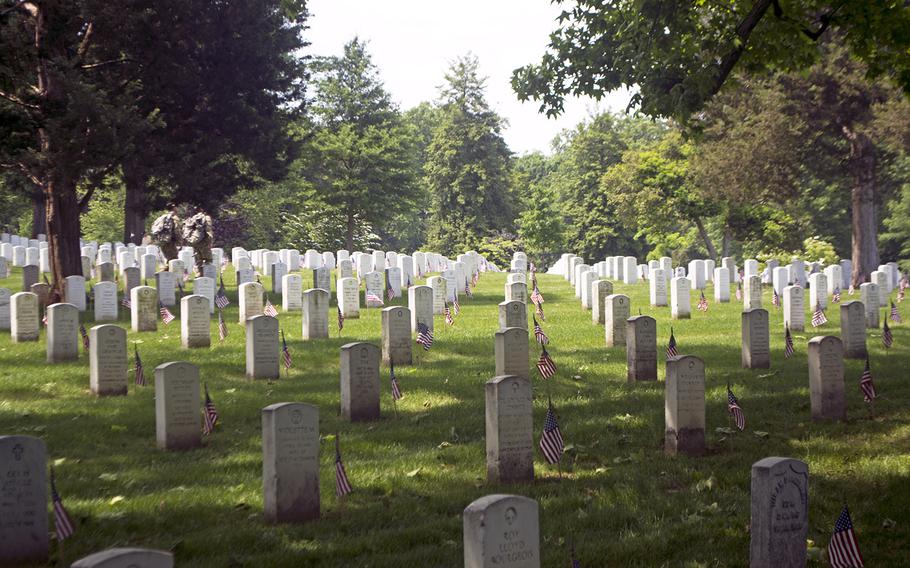 Servicemembers participate in Flags In at Arlington National Cemetery on May 26, 2016.