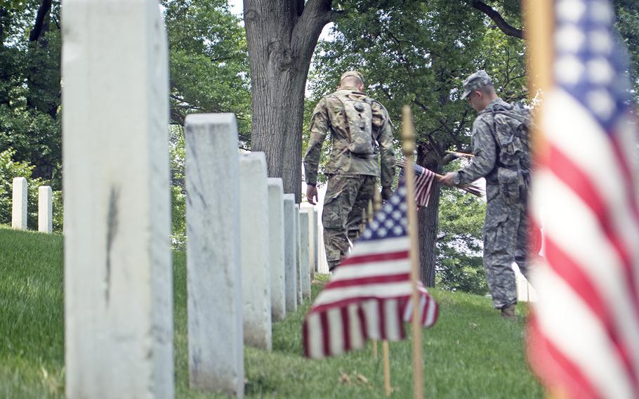 Servicemembers participate in Flags In at Arlington National Cemetery on May 26, 2016.