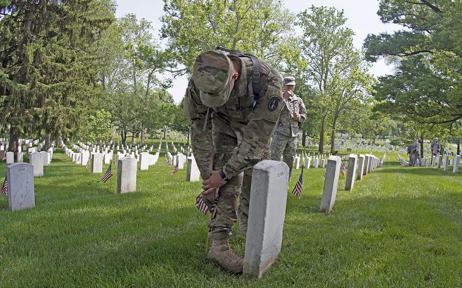 Servicemembers participate in Flags In at Arlington National Cemetery on May 26, 2016.