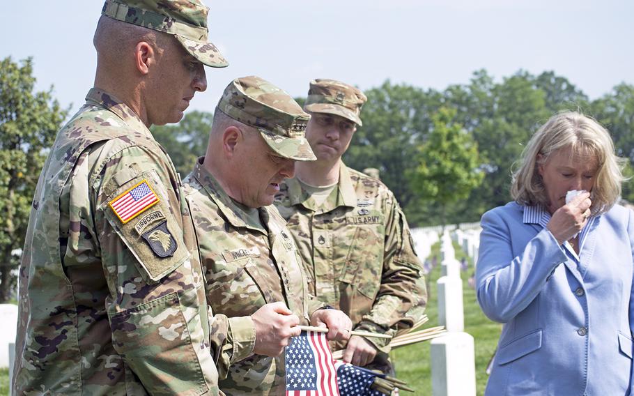 Gen. Milley listens to the history behind a servicemember buried at Section 60 during Flags In at Arlington Nation Cemetery on May 26, 2016.