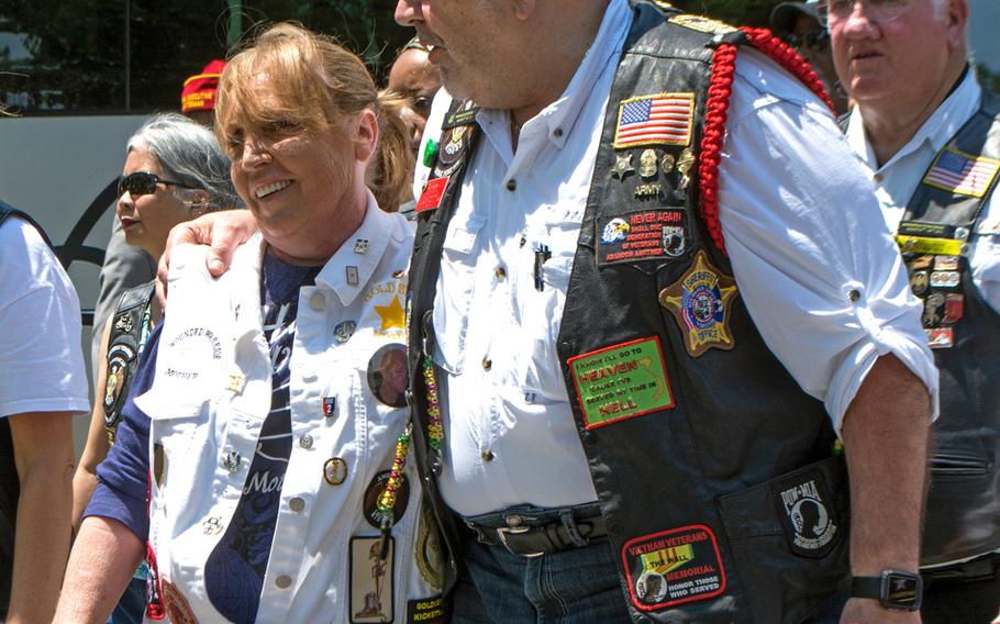 American Legion members hold a wreath-laying ceremony at the Civil War Unknown Monument - the original Tomb of the Unknown Soldier - at Arlington National Cemetery on May 28, 2016. Here, a gold star mother receives a hug from an American Legion member as they walk to the ceremony.