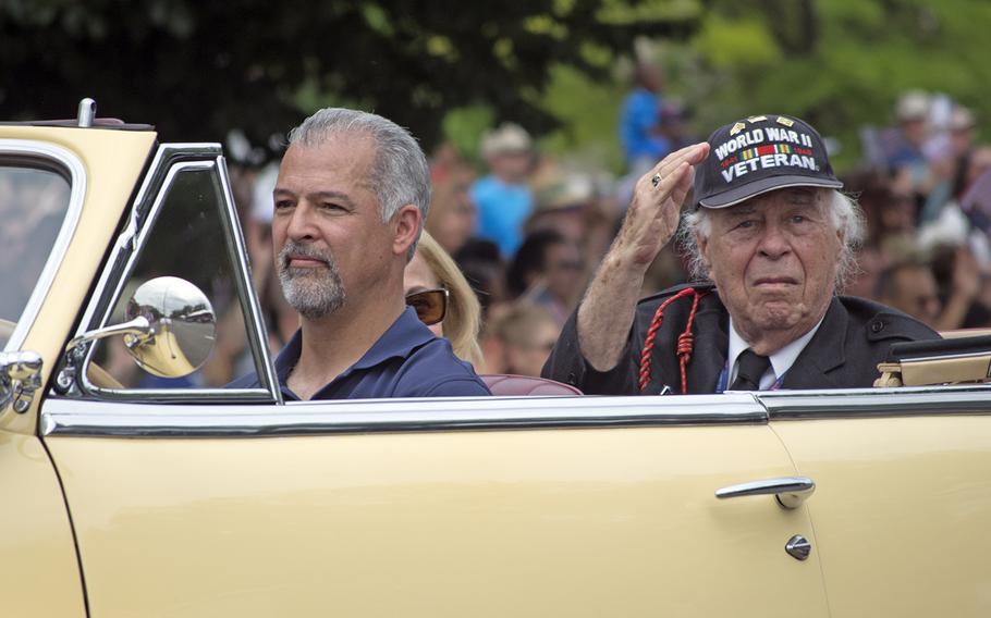 A WWII veteran waves from a car during the 2016 Memorial Day Parade in Washington, D.C.