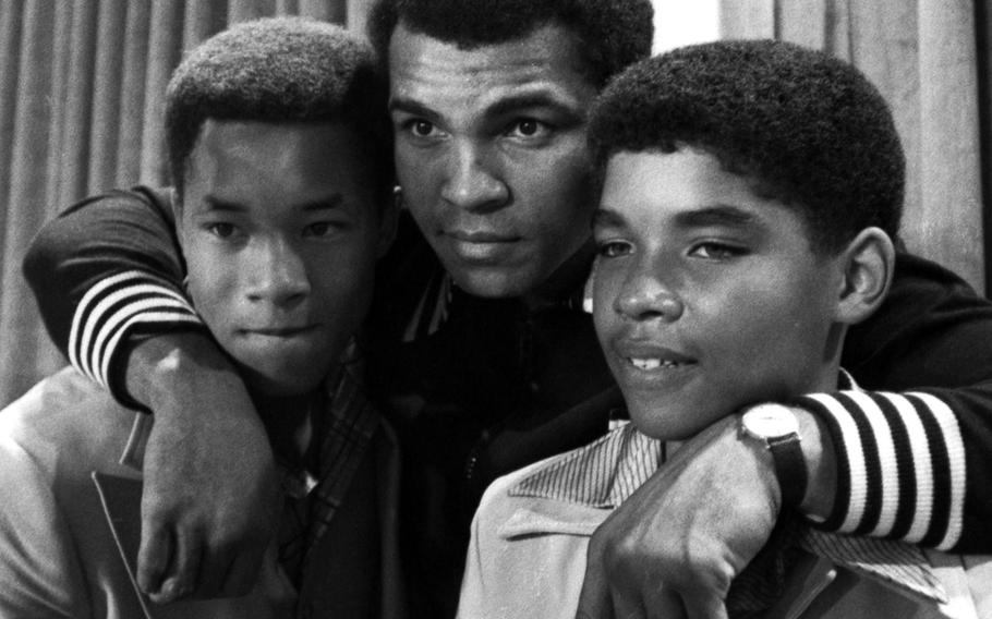 At a New York City press conference in September, 1976, Muhammad Ali poses with Phillip "Chip" McAllister, left, and James Leroy Smith, who play him in his younger days in an upcoming film, "The Greatest," a biography that also stars James Earl Jones, Ernest Borgnine and Robert Duvall. "I predict this is going to be the greatest movie of all time," Ali noted in characteristic fashion. "After all, I am the most famous person in the world ... I'm telling you, Charlton Heston is in trouble, Steve McQueen is in trouble, Paul Newman is in trouble, Robert Redford is in trouble. They're all in trouble now."