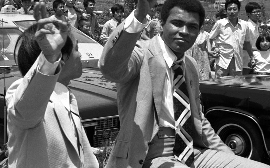 Muhammad Ali in South Korea in June, 1976. Ali, who had recently taken part in a boxing-wrestling match against Antonio Inoki in Tokyo, was greeted by thousands of Koreans who lined his motorcade route from the airport to Seoul.